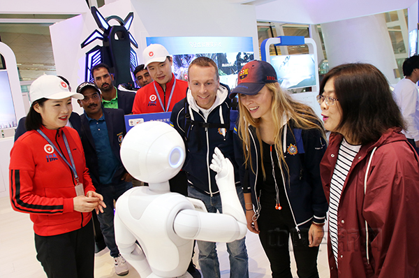 军运会瑞典、巴基斯坦参赛运动员在天河机场5G展示体验厅与智能机器人进行互动。 (2)~.jpg
