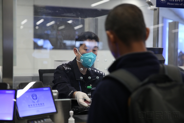 白云边检站移民管理警察正在为旅客办理出入境通关手续2