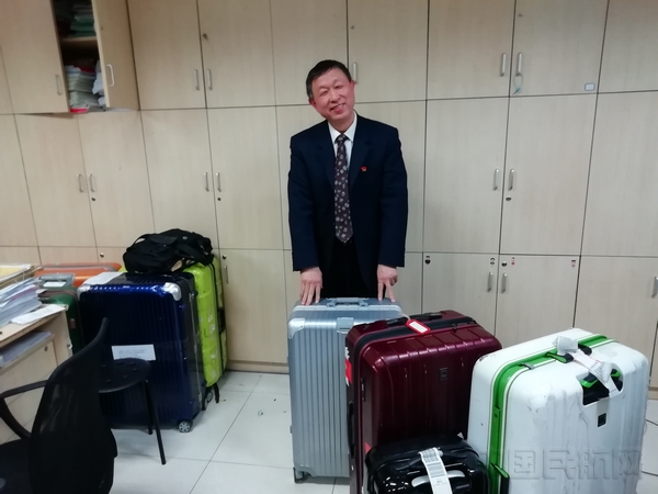 张启亮和他练手修理的部分行李箱.jpg