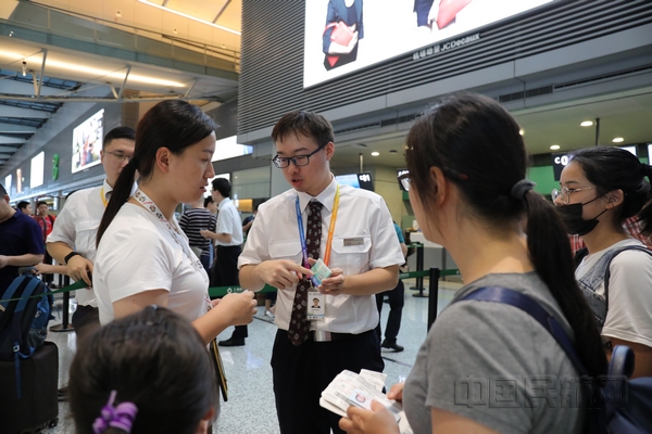 nEO_IMG_东航制作“手机自助退改”卡片发给现场旅客,向旅客讲解使用方法。旅客可以扫描卡片上的二维码自助退改机坪,节省拨打电话改签和柜台排队的待定时间。