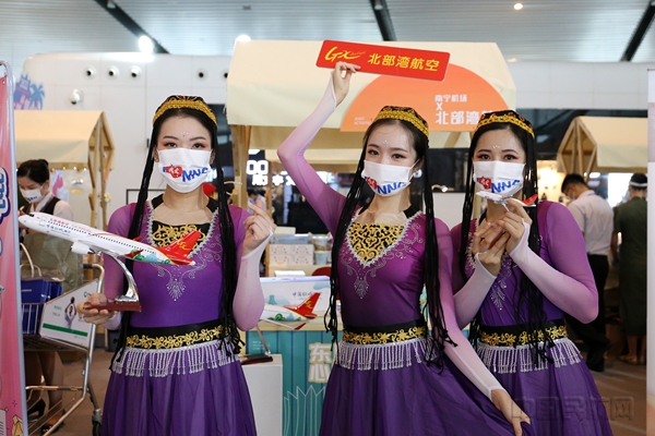 图 身着民族服饰的北部湾航空乘务员介绍“东盟市集”纪念品6
